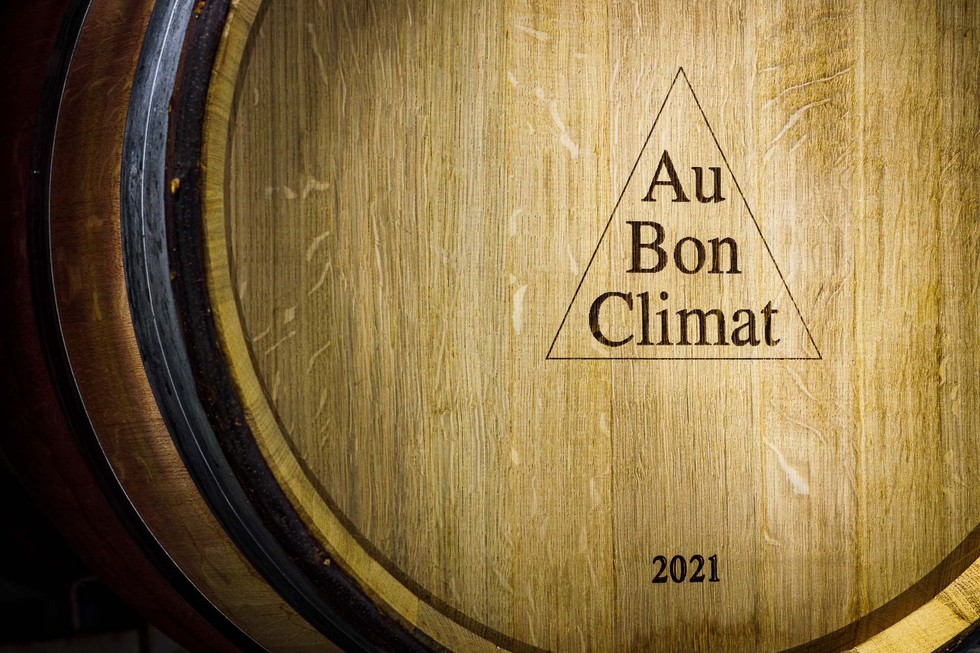 Wine barrel laying in the rack with Au Bon Climat logo and 2021 branded on the top.