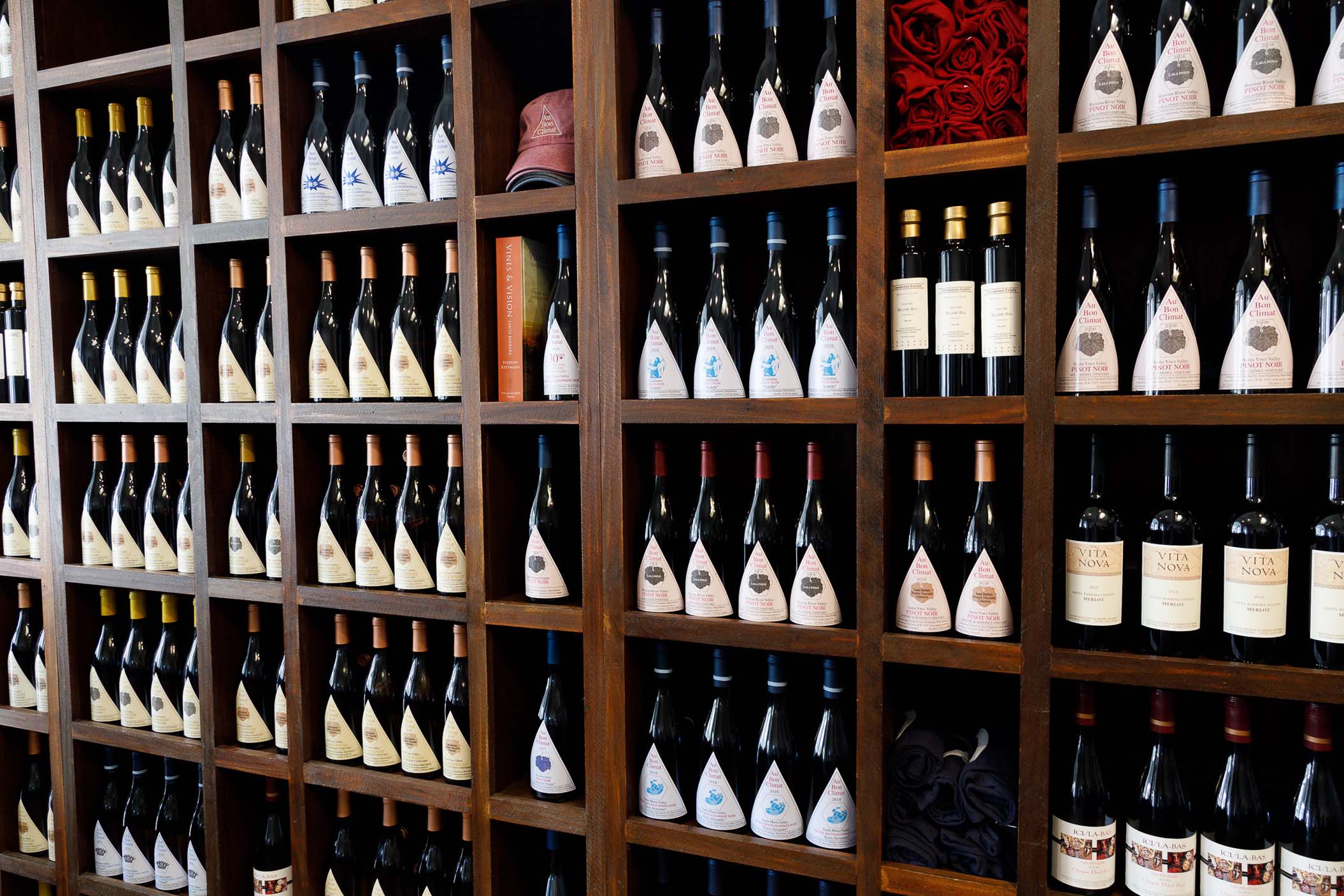 The wine wall at Au Bon Climat tasting room in Santa Barbara, California, showing various bottles of Au Bon Climat wines